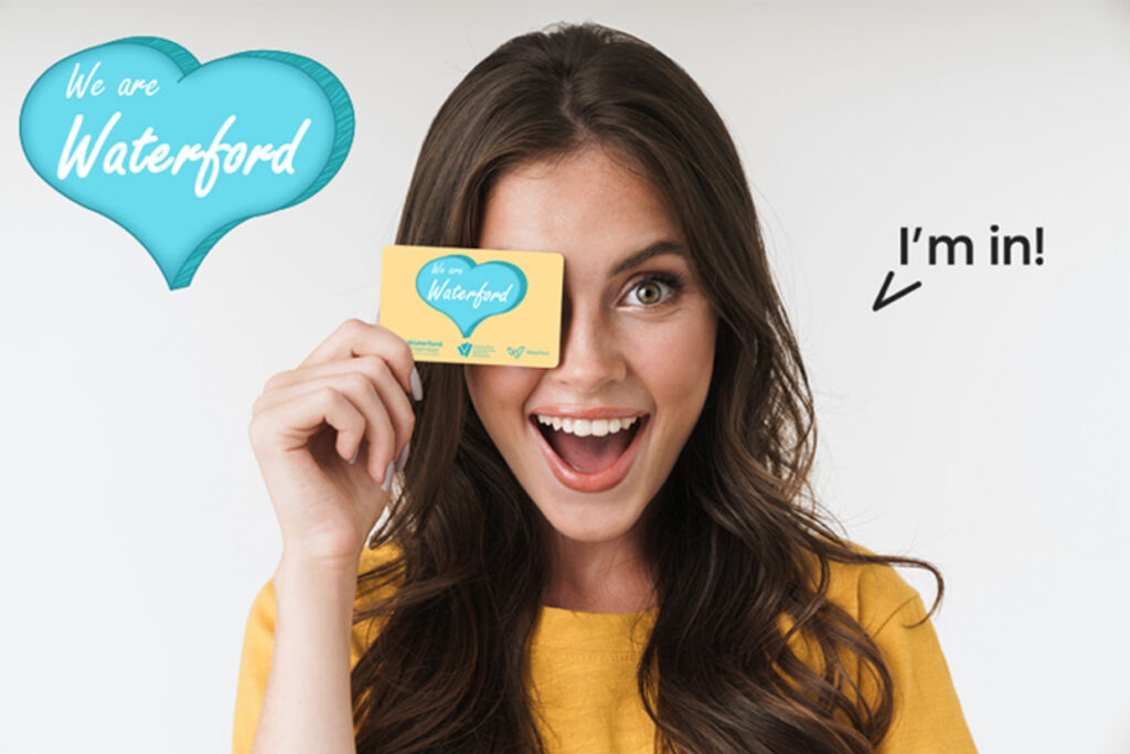 I'm in! Campaign. Young african man holding a WE ARE Waterford card.