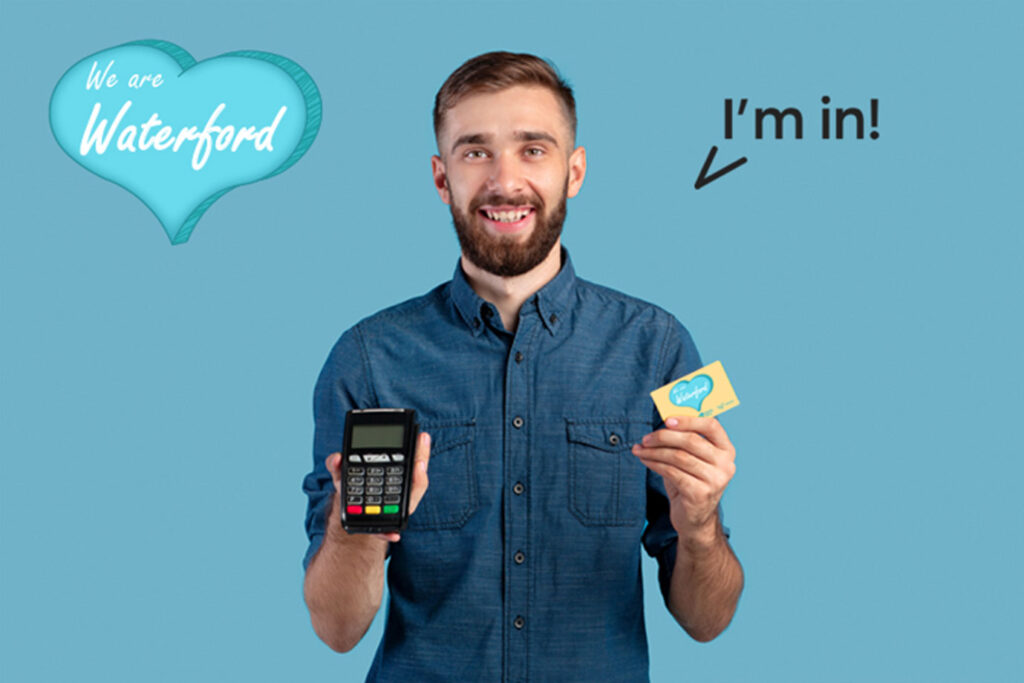 A man holding the We Are Waterford Card